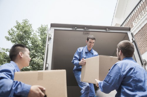 Piano removals team carefully moving an upright piano in Crystal Palace