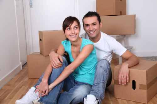 Professional movers handling office items in a South London property