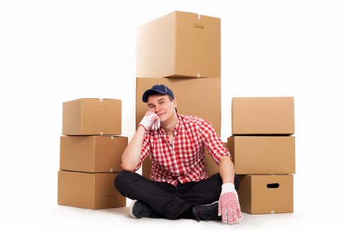 Movers handling furniture from a local flat staircase